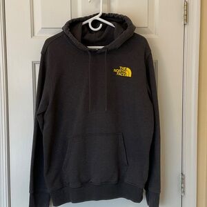 The North Face Men's Dark Gray Hoodie with Yellow Emblem